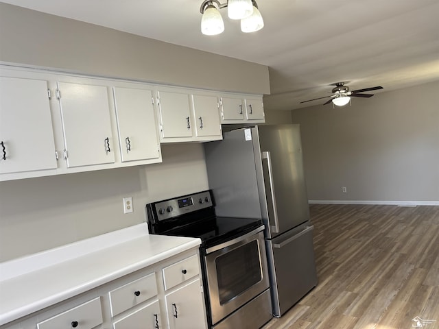 kitchen with stainless steel electric range oven, light wood-type flooring, light countertops, and white cabinetry