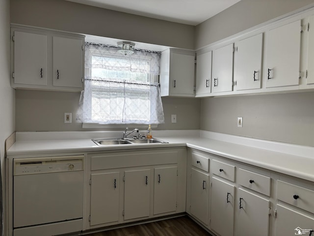 kitchen featuring a sink, white dishwasher, white cabinetry, and light countertops