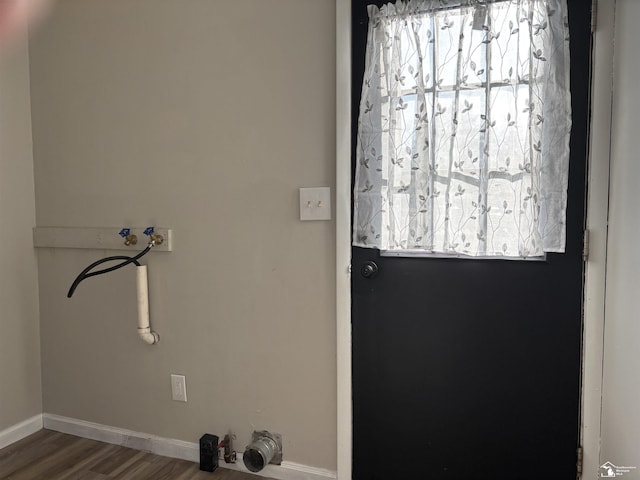 washroom with wood finished floors and baseboards