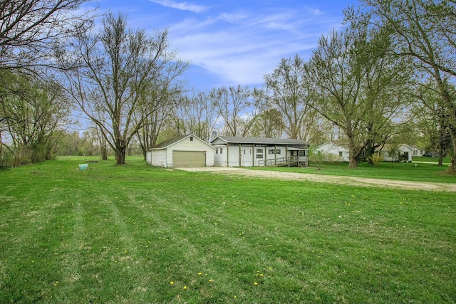 view of yard featuring a garage and driveway