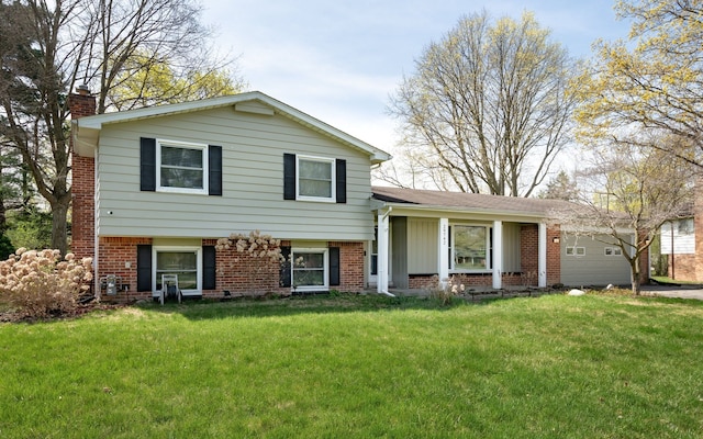 29742 Old Bedford St, Farmington Hills, MI 48331 - split level home with a chimney, brick siding, a front lawn, and a garage
