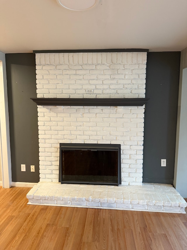 2976 Giddings Blvd, Highland, MI 48356 - room details with baseboards, wood finished floors, and a fireplace