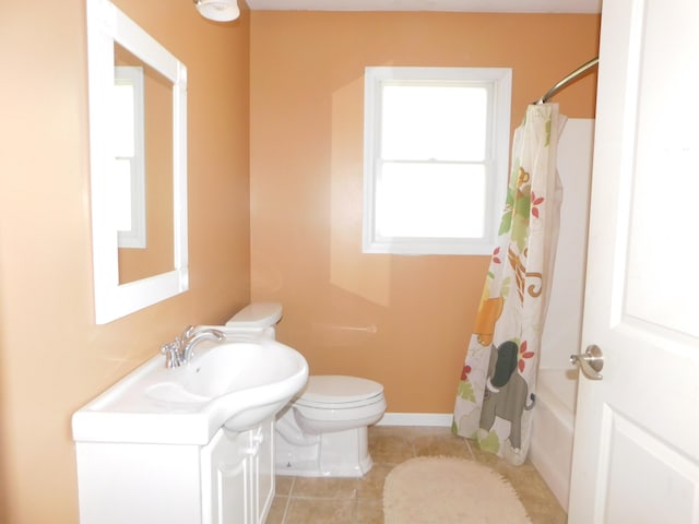 bathroom featuring tile patterned flooring, shower / bathtub combination with curtain, toilet, vanity, and baseboards