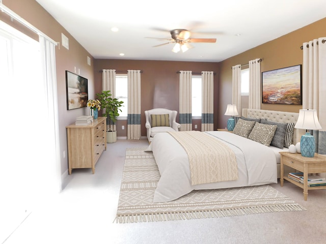 bedroom featuring baseboards, visible vents, ceiling fan, and light colored carpet