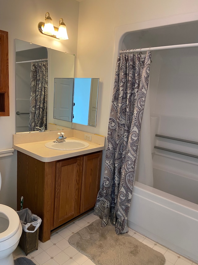 full bath with tile patterned floors, shower / tub combo, vanity, and toilet