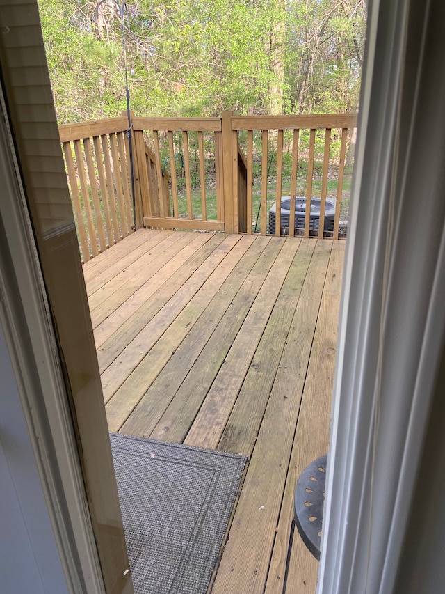 wooden terrace featuring cooling unit