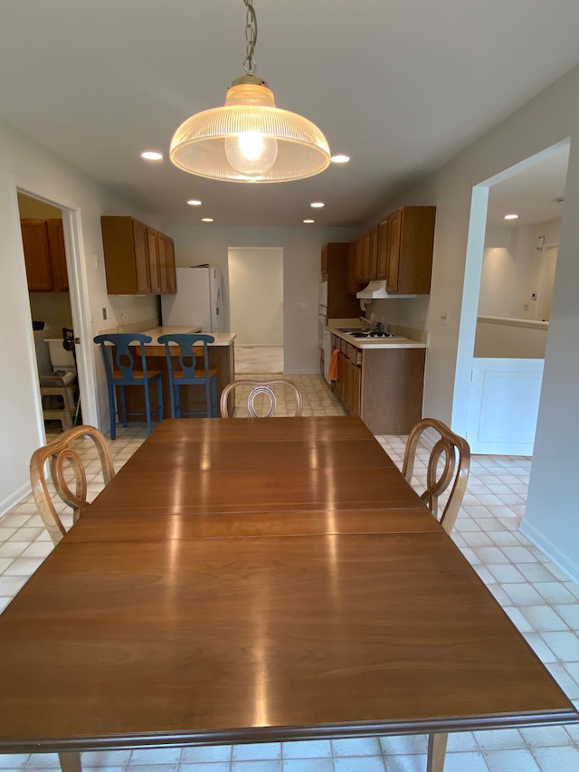 dining space featuring light tile patterned floors and recessed lighting