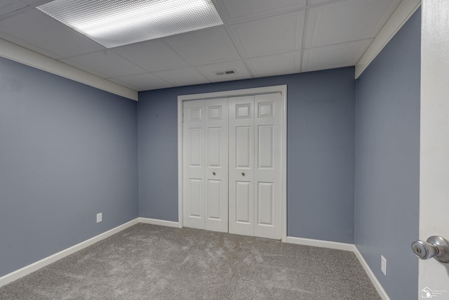unfurnished bedroom featuring a closet, carpet flooring, visible vents, and baseboards