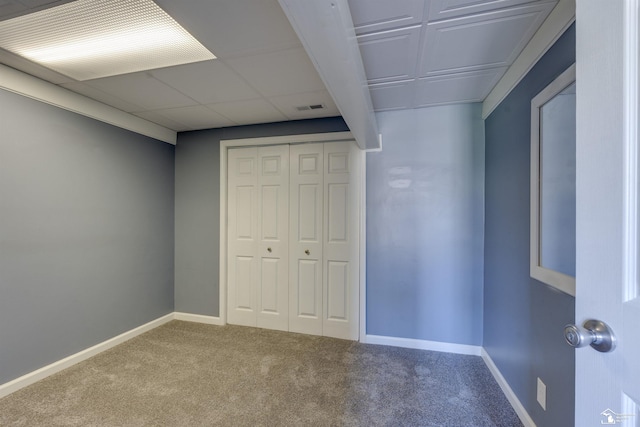 unfurnished bedroom with a closet, visible vents, carpet, and baseboards