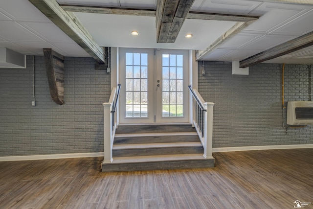 staircase featuring recessed lighting, brick wall, heating unit, baseboards, and wood finished floors