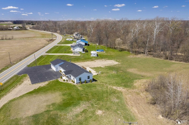 birds eye view of property with a forest view