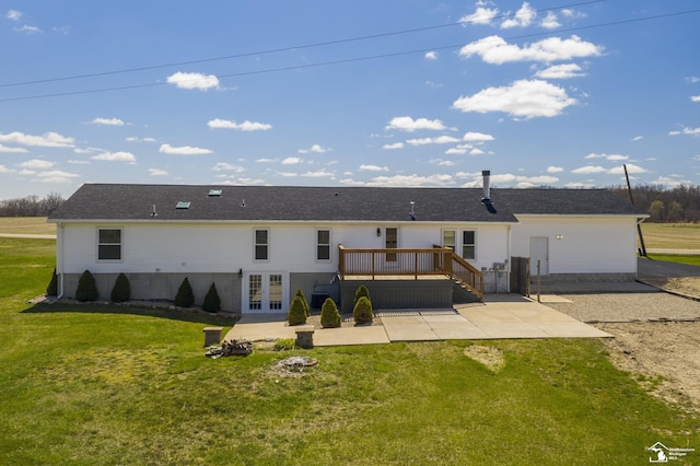 rear view of house featuring a deck, a yard, and a patio area