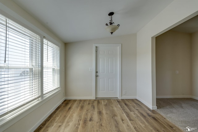 interior space with light wood-style flooring, a wealth of natural light, and baseboards