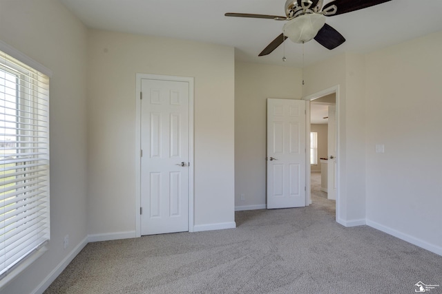 unfurnished bedroom with baseboards, a ceiling fan, and carpet floors
