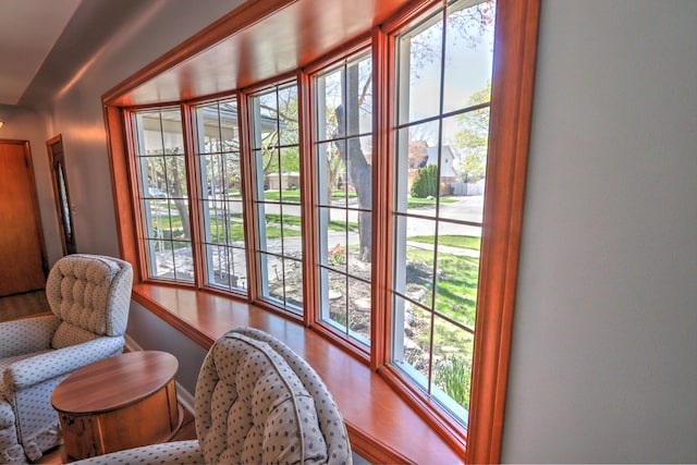 doorway to outside with baseboards and wood finished floors