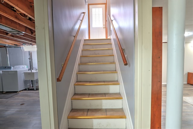 stairway featuring wood finished floors and washing machine and clothes dryer