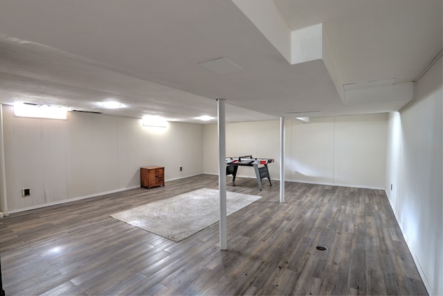 finished basement featuring baseboards and wood finished floors