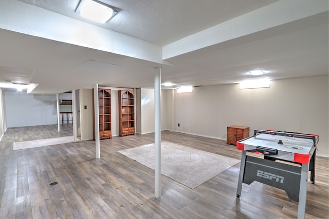 finished basement with baseboards and wood finished floors