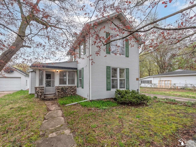 traditional home with an outbuilding and a front yard