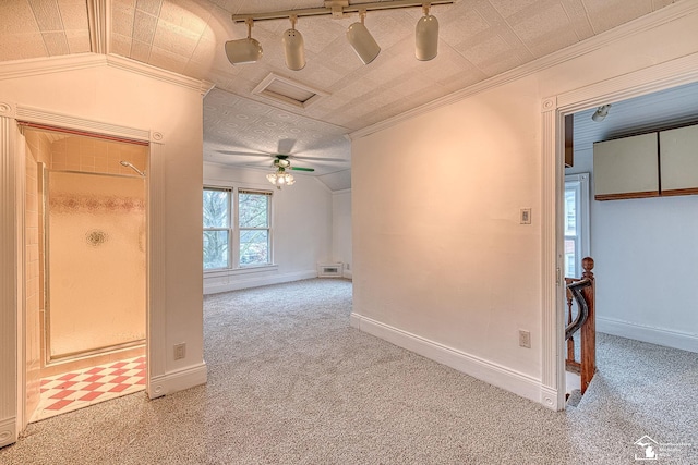carpeted spare room with baseboards, ornamental molding, and an ornate ceiling