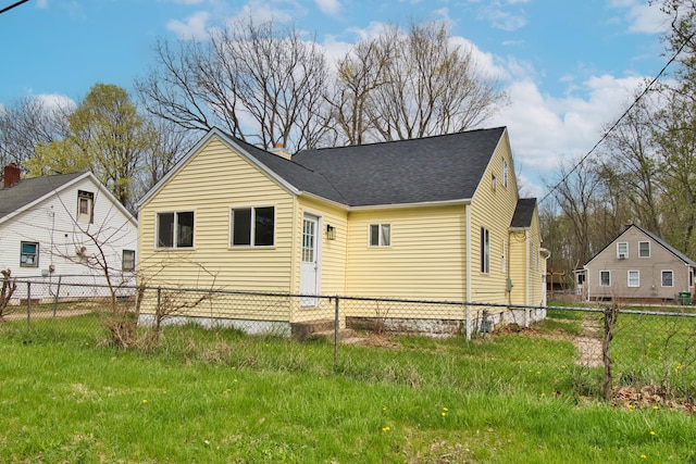 rear view of property with roof with shingles and fence