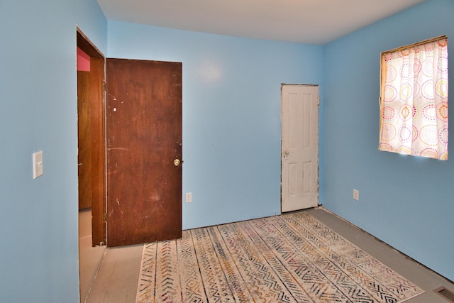 unfurnished bedroom with light wood-style flooring