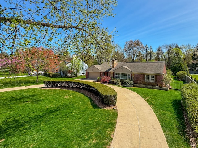 ranch-style home featuring driveway, a chimney, a garage, fence, and a front lawn