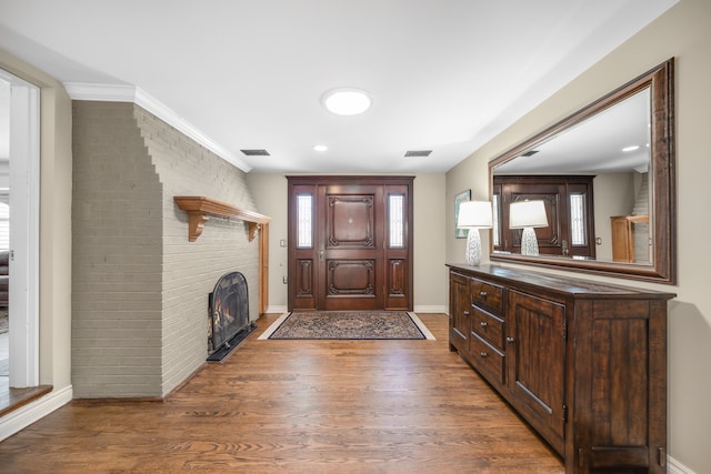 entryway with visible vents, baseboards, and wood finished floors