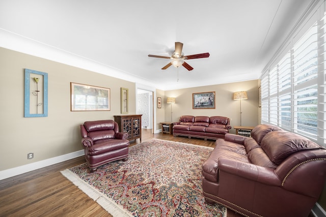 living room featuring baseboards, ceiling fan, and wood finished floors