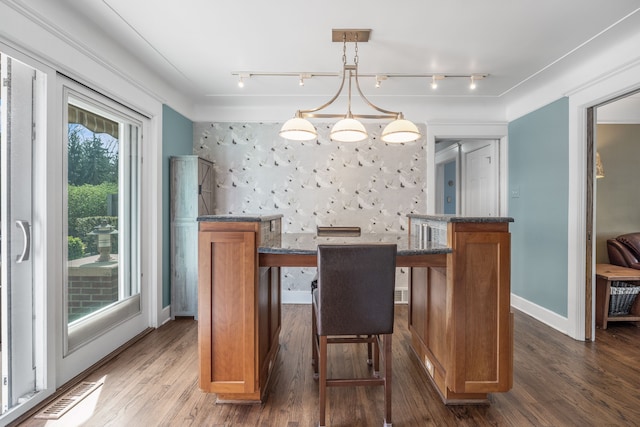 dining area featuring track lighting, baseboards, dark wood finished floors, and visible vents