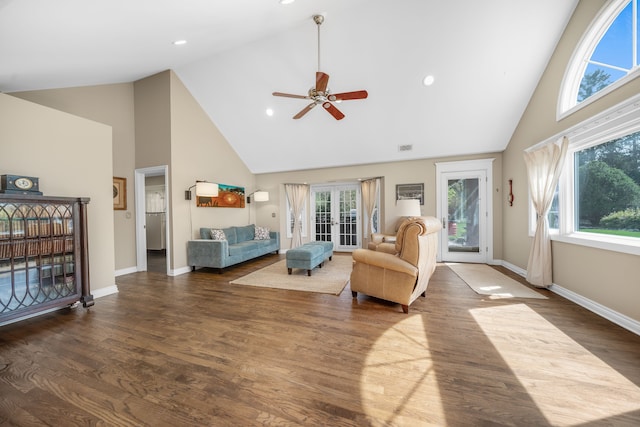 living area with baseboards, a ceiling fan, high vaulted ceiling, and wood finished floors