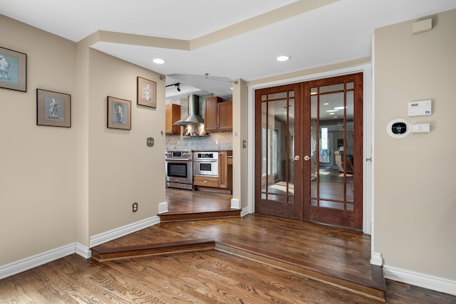 entrance foyer featuring recessed lighting, baseboards, french doors, and wood finished floors