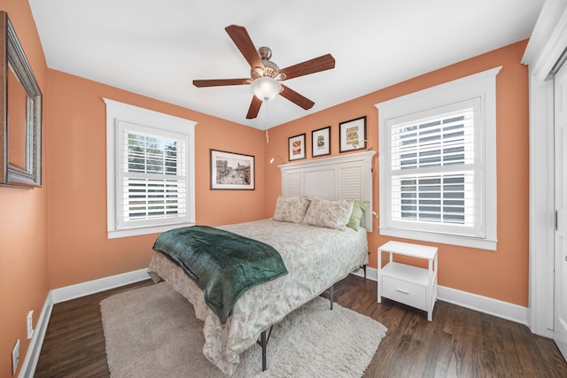 bedroom featuring baseboards, a ceiling fan, and dark wood-style floors