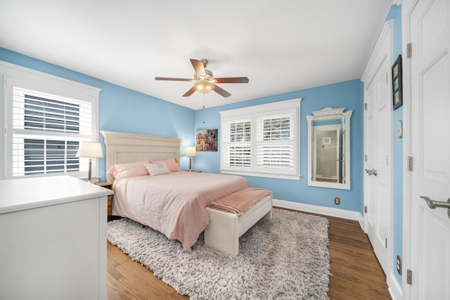 bedroom featuring baseboards, ceiling fan, and dark wood-type flooring