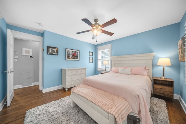 bedroom featuring baseboards, a ceiling fan, and wood finished floors