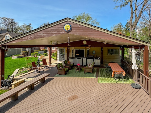 wooden deck featuring exterior bar and a yard