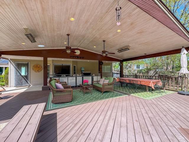 wooden terrace with fence, a ceiling fan, and outdoor lounge area
