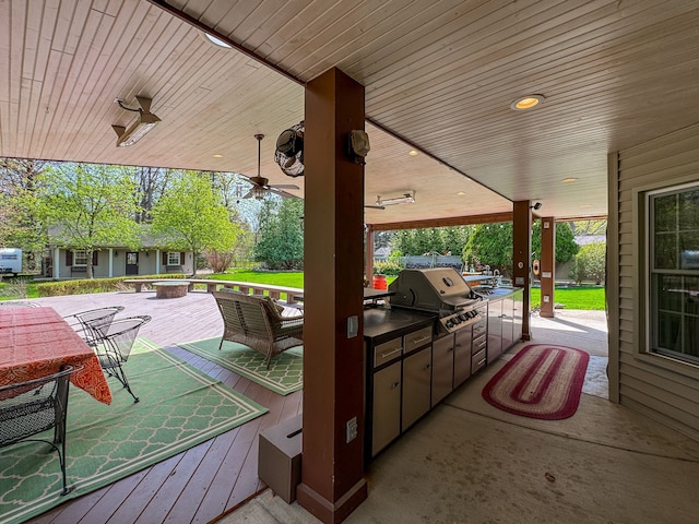 view of patio featuring a ceiling fan, a grill, area for grilling, and a deck
