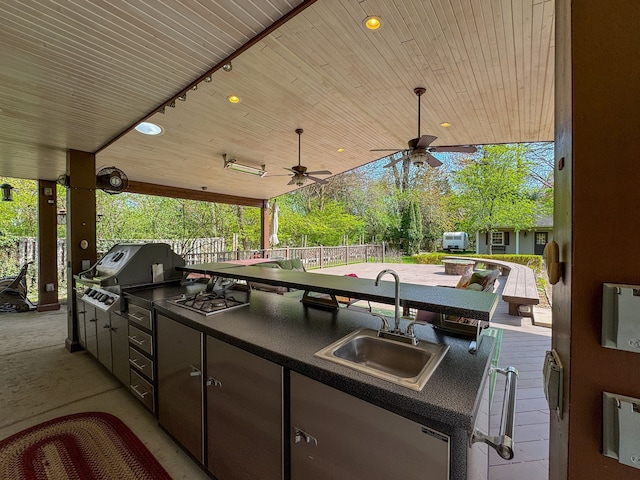 view of patio / terrace featuring fence, a sink, a ceiling fan, and area for grilling