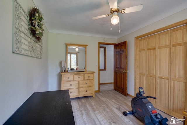 interior space with light wood finished floors, a ceiling fan, a closet, and baseboards