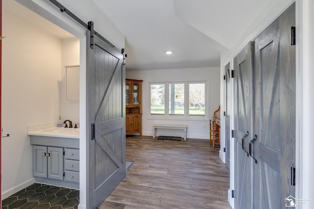 bathroom featuring lofted ceiling, baseboards, recessed lighting, wood finished floors, and vanity