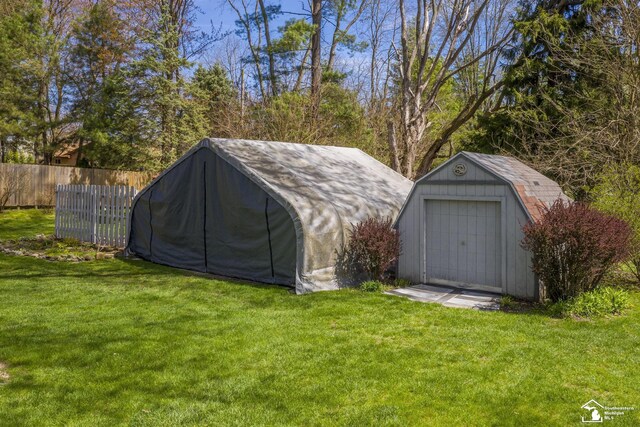 view of shed featuring fence