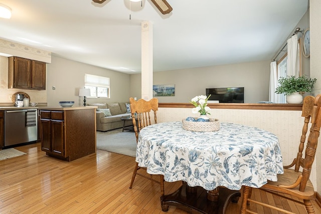 dining room with ceiling fan and light wood-type flooring
