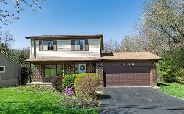 traditional home with brick siding, a garage, aphalt driveway, and a porch