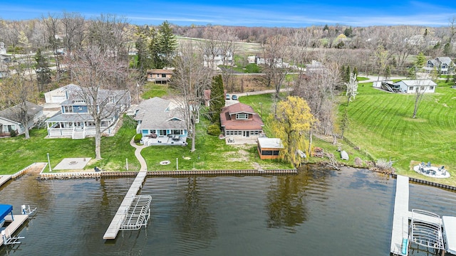 birds eye view of property with a water view and a residential view