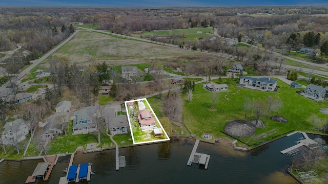 drone / aerial view featuring a water view and a view of trees