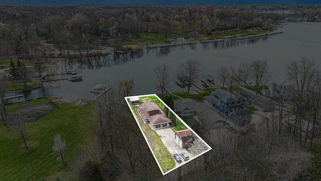 birds eye view of property featuring a water view and a view of trees