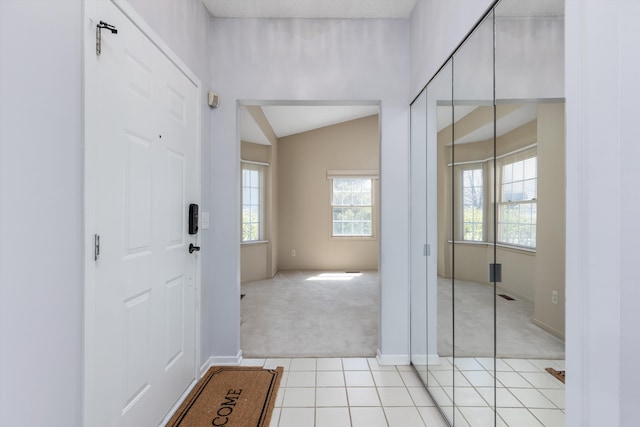 30701 Sandalwood Cir, Novi, MI 48377 - foyer entrance with lofted ceiling, light tile patterned floors, baseboards, and light carpet
