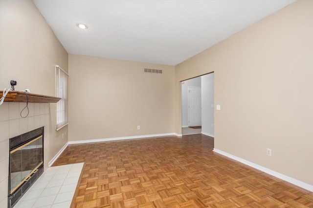 30701 Sandalwood Cir, Novi, MI 48377 - unfurnished living room featuring visible vents, a tiled fireplace, and baseboards