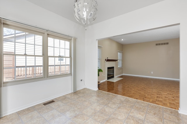 30701 Sandalwood Cir, Novi, MI 48377 - unfurnished living room featuring baseboards, visible vents, and a fireplace with flush hearth